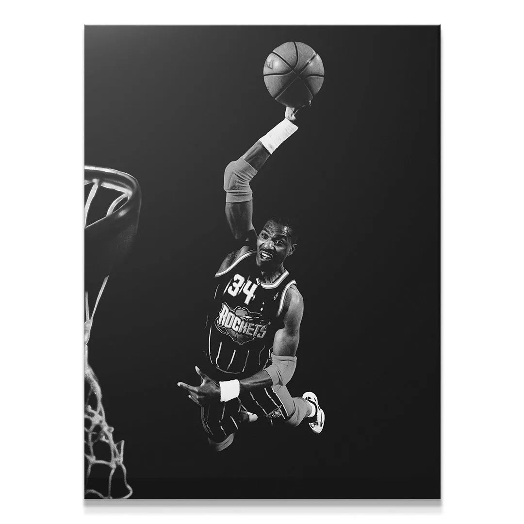 Hakeem Olajuwon - #1 executing a massive dunk, captured in dramatic black and white gallery lighting.