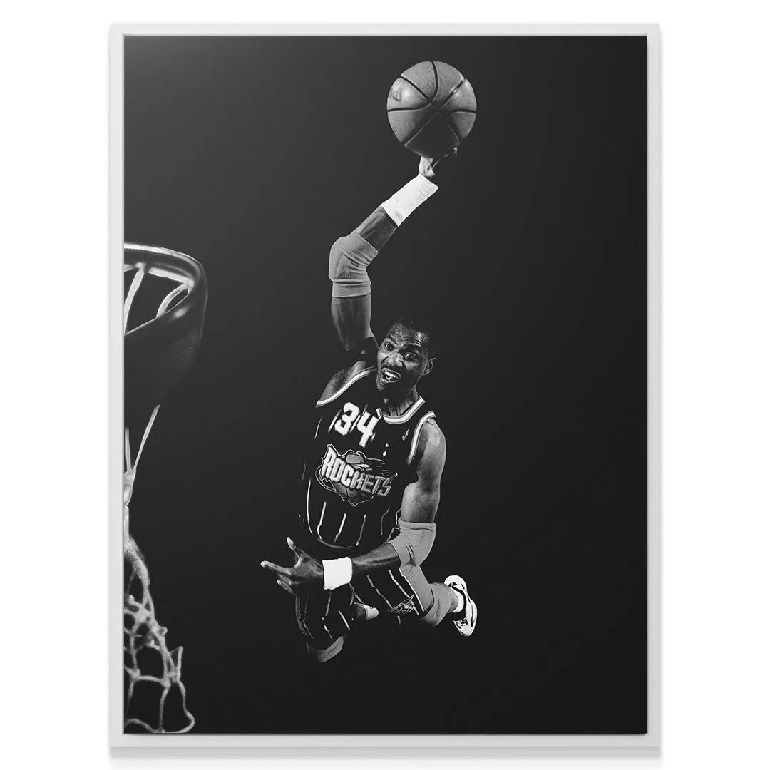 Textured canvas print of Hakeem Olajuwon - #1 holding the basketball high above the rim in his Rockets jersey.