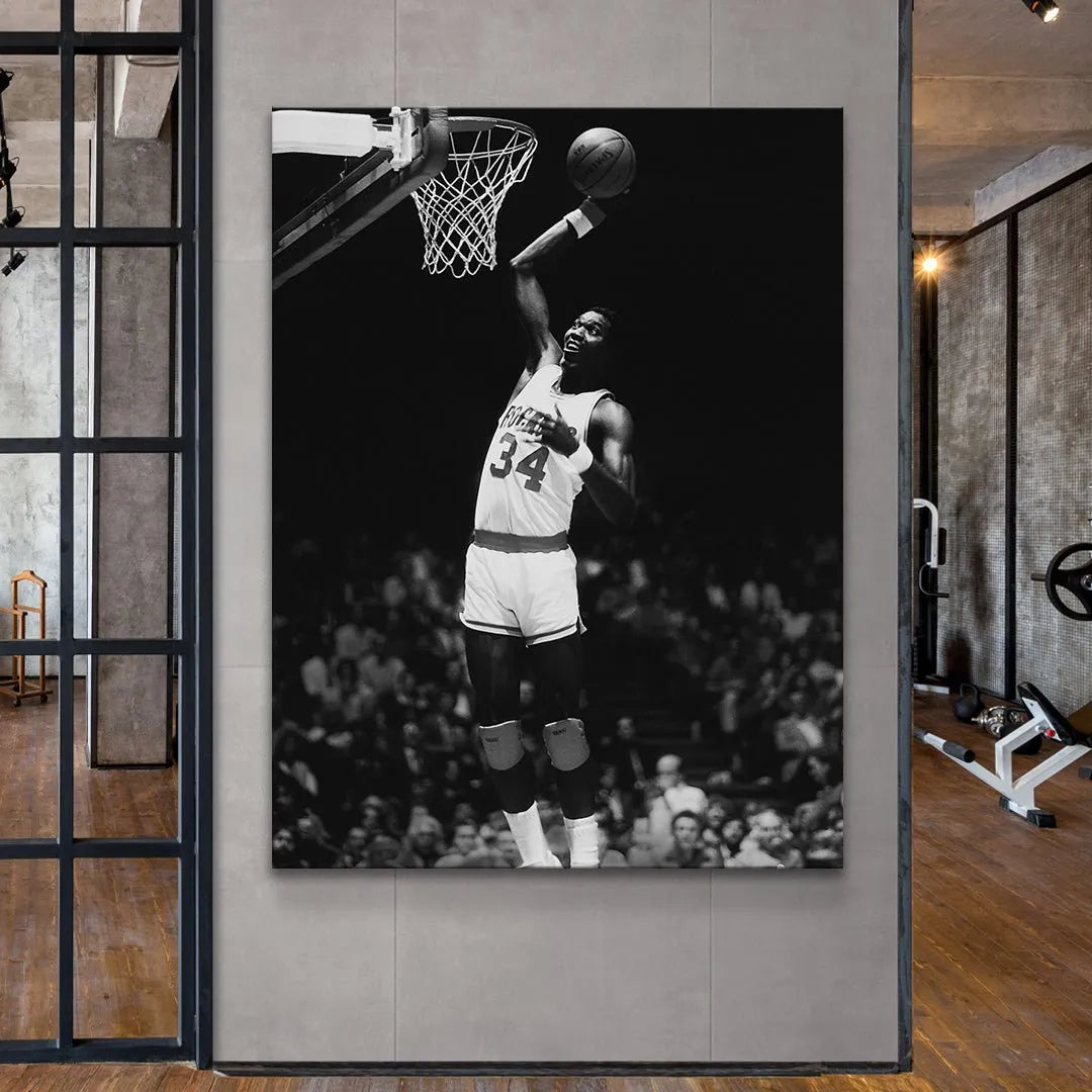 Vertical angle view showing Hakeem Olajuwon - #2 mid-dunk looking up intensely at the rim.