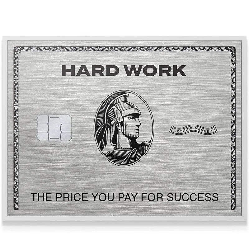 Low-angle shot emphasizing the silver sheen and thickness of the commemorative Hard Work Card.