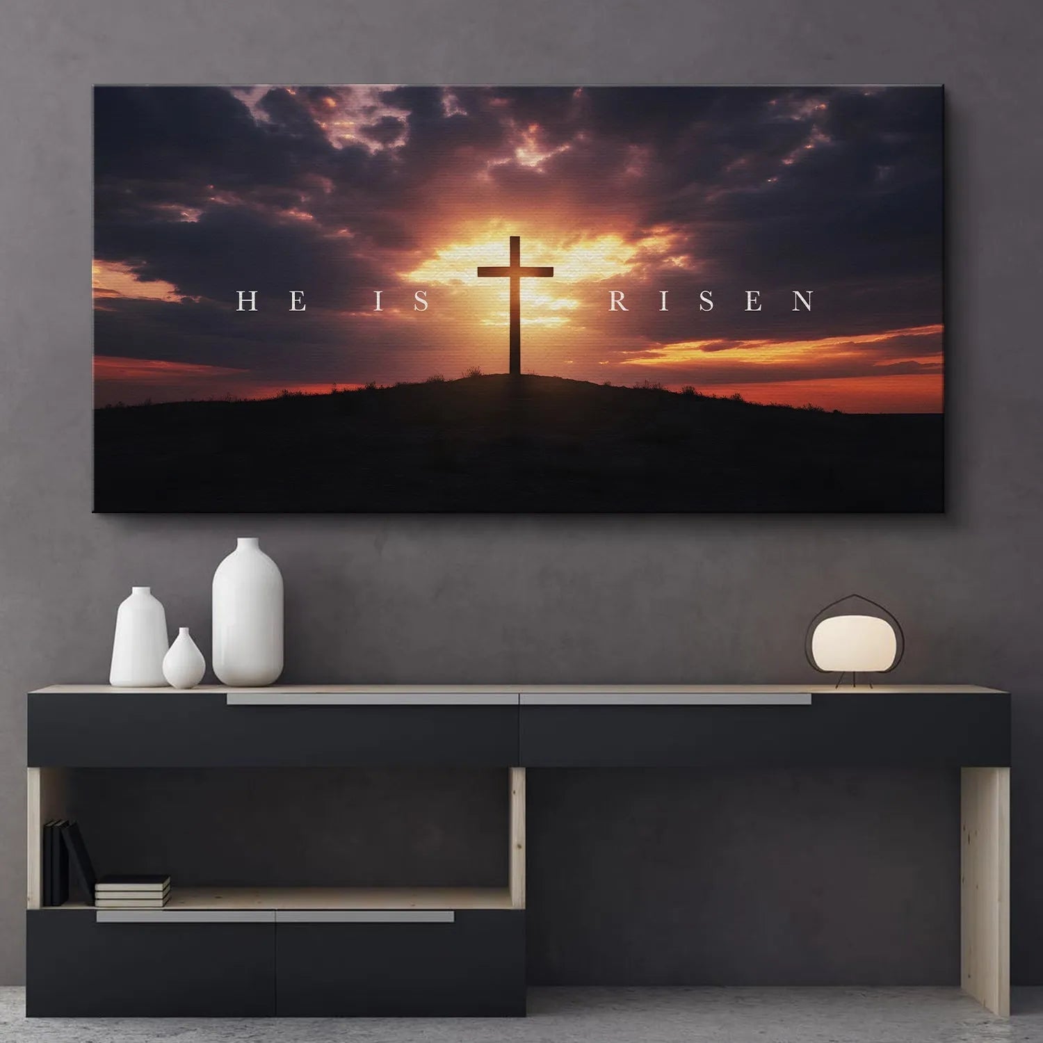 High-angle shot emphasizing the dark, dramatic cloud texture above the text on the 'He Is Risen – Cross' artwork.