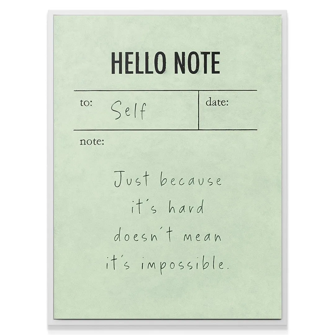 Lifestyle image of the Hello Note (Green) placed on a wooden desk next to a pen and coffee.