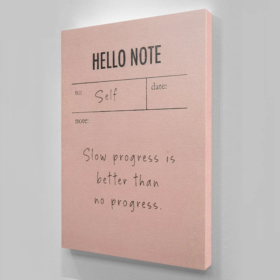 Lifestyle image of the Hello Note (Pink) placed on a wooden desk next to a pen.