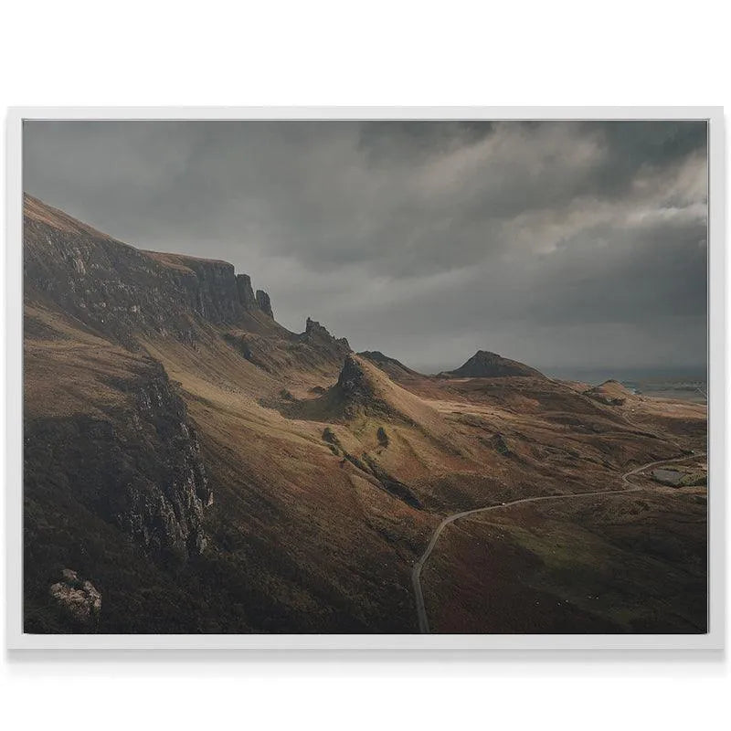 Low-angle perspective of the towering, Quiraing-like peaks under dark clouds captured in 'Highland Roar'.