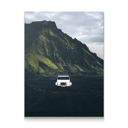 White off-road vehicle driving toward the viewer in the Icelandic Highlands.