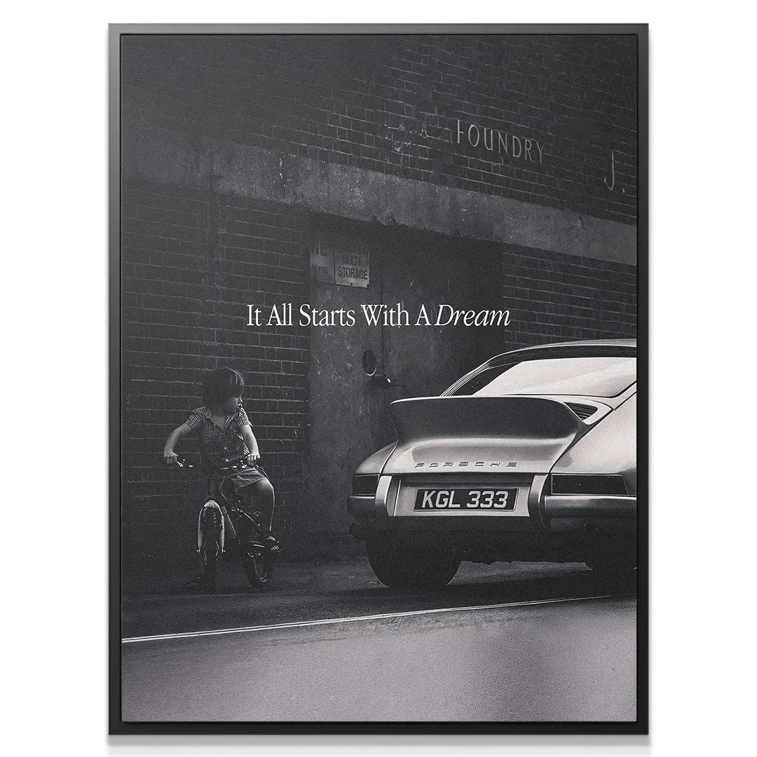 Close-up of the child on the small bicycle next to the massive sports car, embodying the spirit of 'It All Starts With A Dream'.