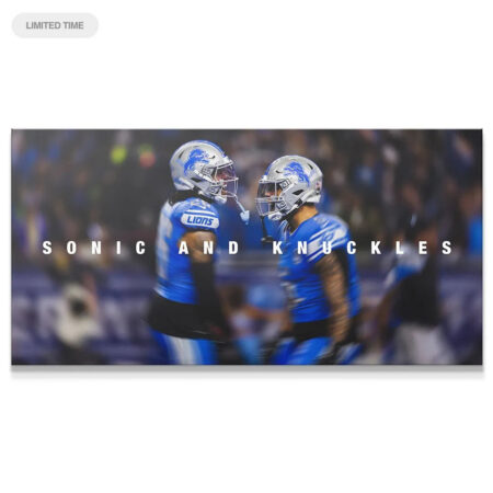 Full horizontal view of Jahmyr Gibbs & David Montgomery - Sonic & Knuckles on the field, wearing reflective silver helmets.