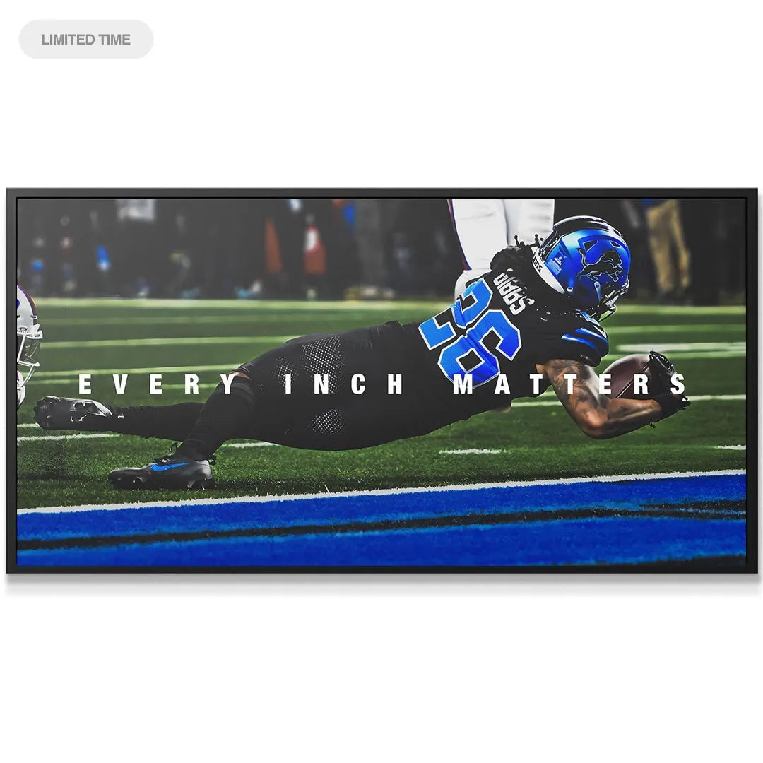 Jahmyr Gibbs - Every Inch Matters: Close-up detail of the number 26 jersey and blue helmet during the critical dive.
