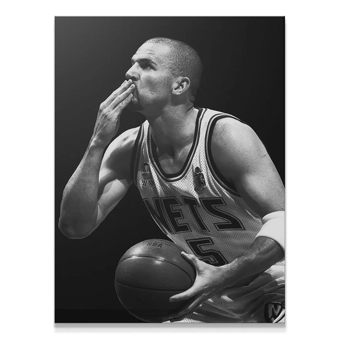 High-contrast black and white action shot of Jason Kidd - #1 blowing a kiss to the crowd during a Nets game.