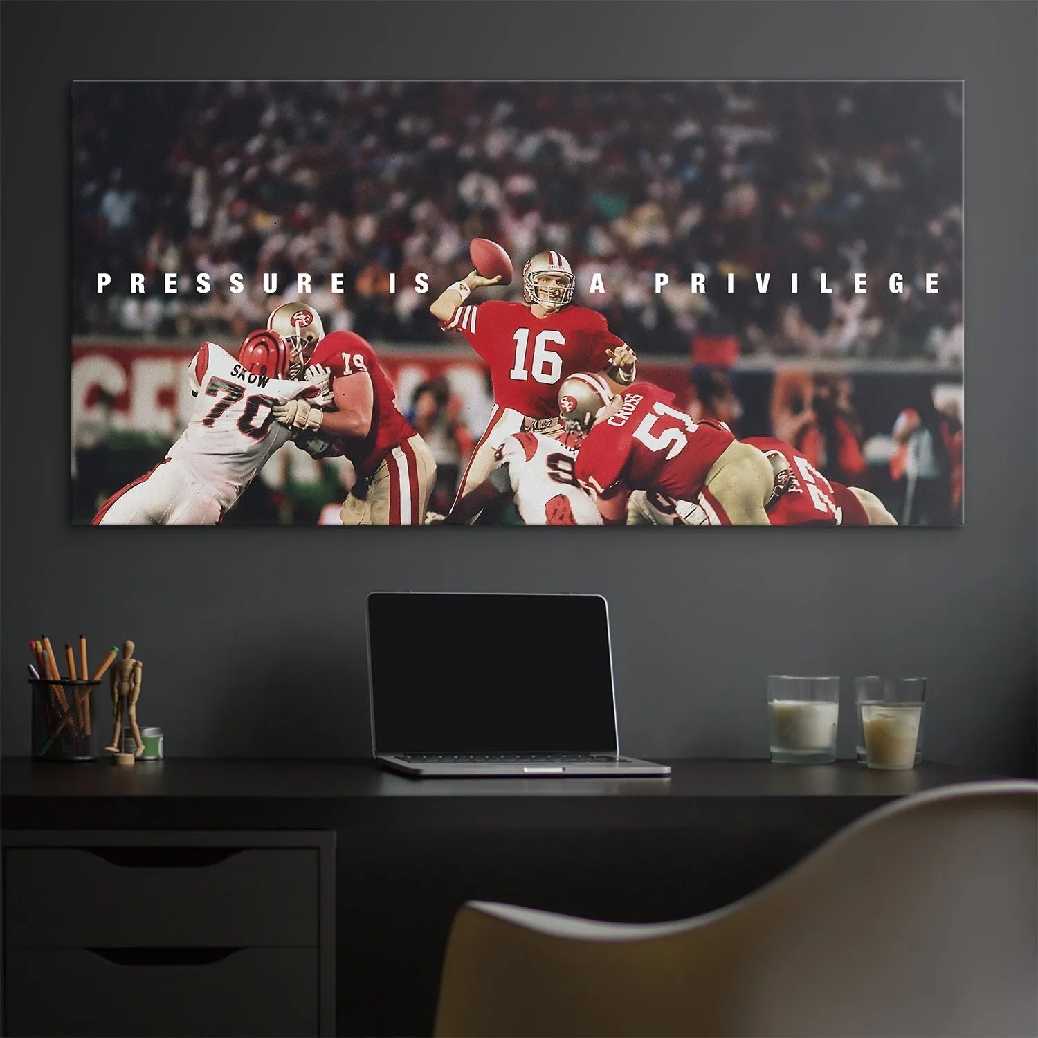 Lifestyle shot of the framed print Joe Montana - Pressure Is A Privilege hanging in a modern office environment.