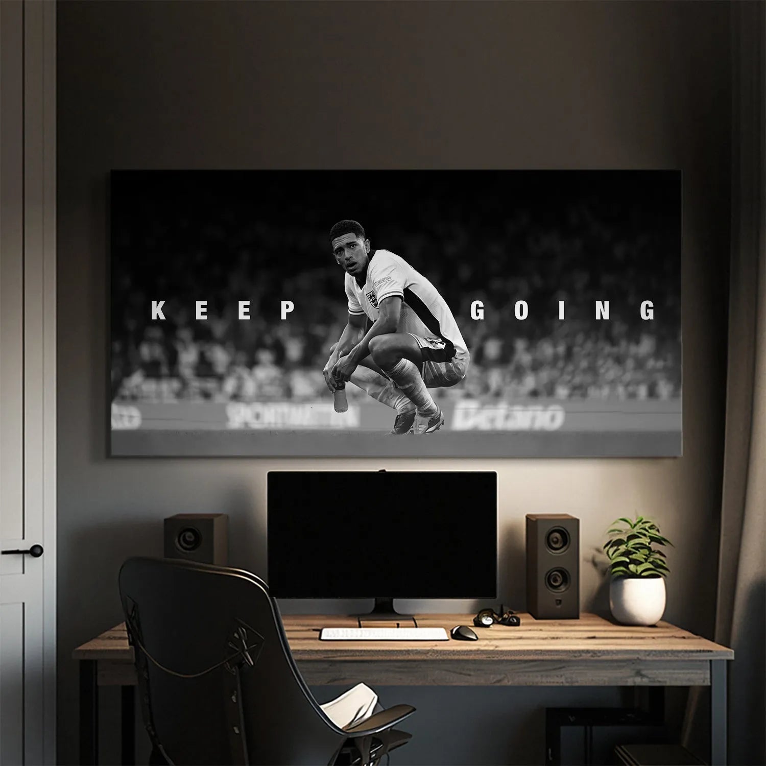 Wide angle showing the blurred stadium background behind the crouching figure in the 'Jude Bellingham - Keep Going' print.