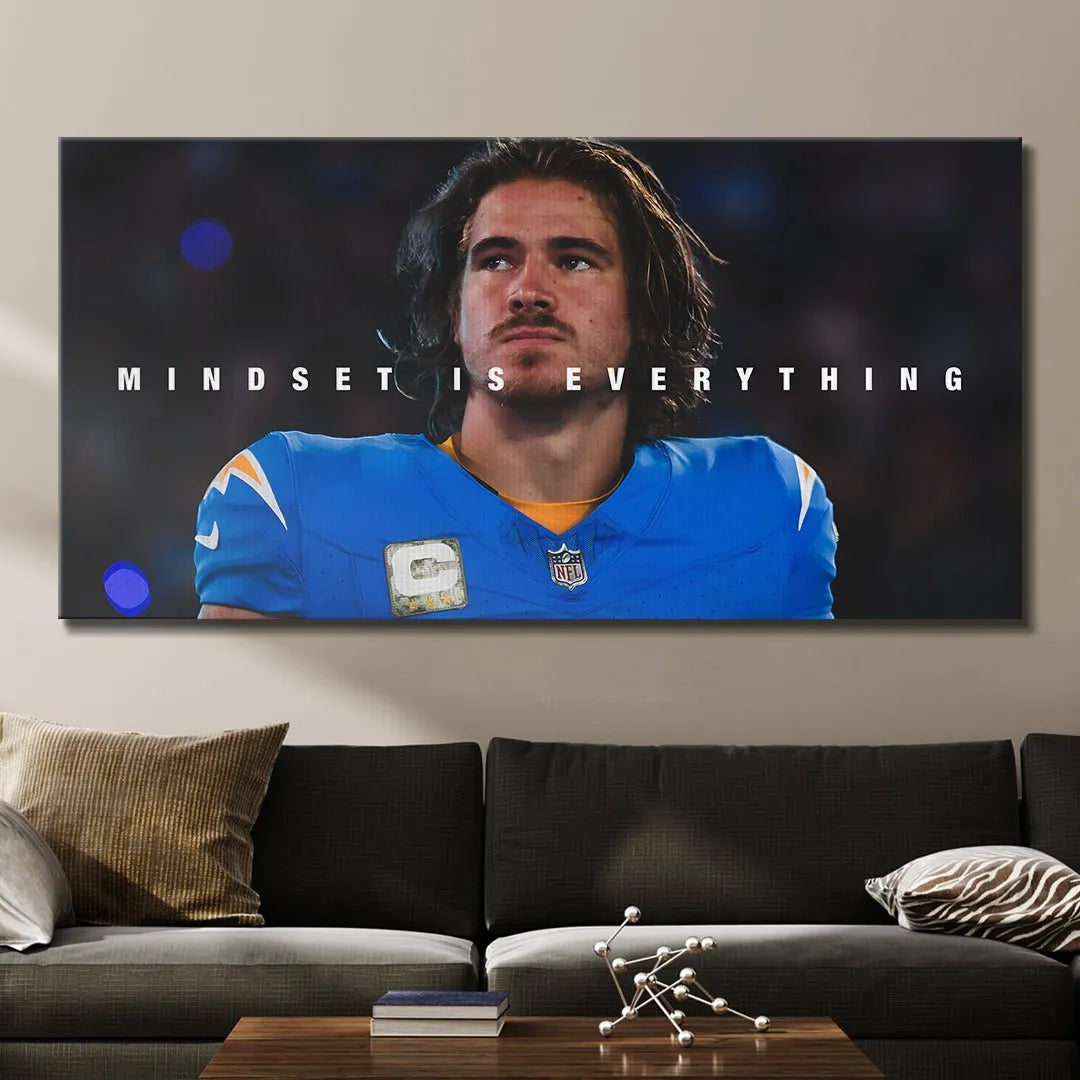 Lifestyle mock-up displaying the motivational poster "Justin Herbert - Mindset Is Everything" mounted aesthetically in a modern office.
