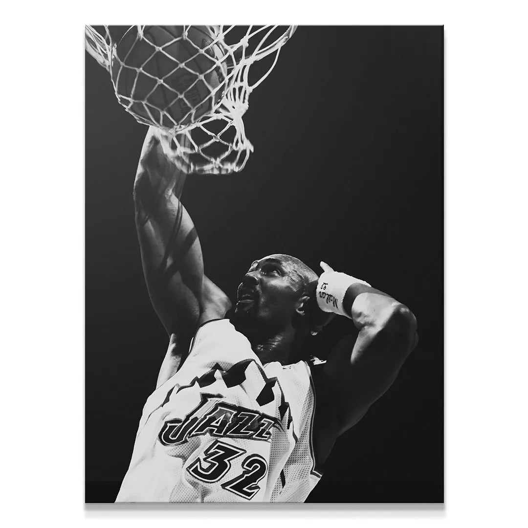 Close-up on the power and focus of Karl Malone - #1 during a successful dunk.
