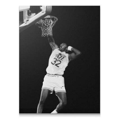 Close-up view of Karl Malone - #2 mid-dunk, focusing on his intense expression and muscular arm holding the rim.