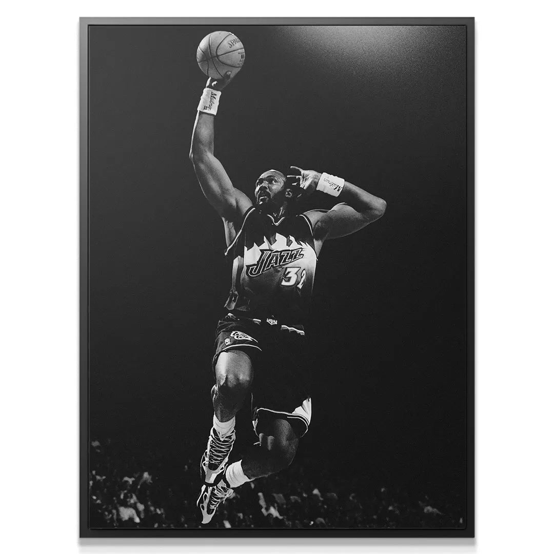 Monochrome print capturing the intense focus and expression of Karl Malone - #4 mid-flight.