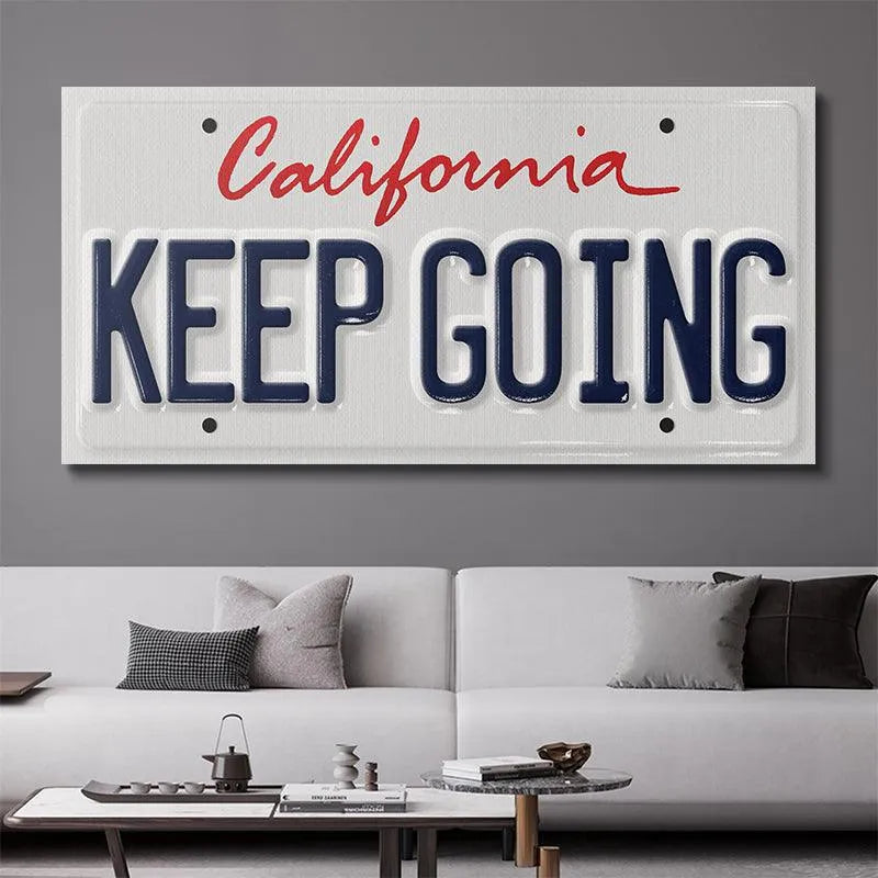 Detail of the red script "California" above the motivational phrase on the 'Keep Going - CA' plaque.