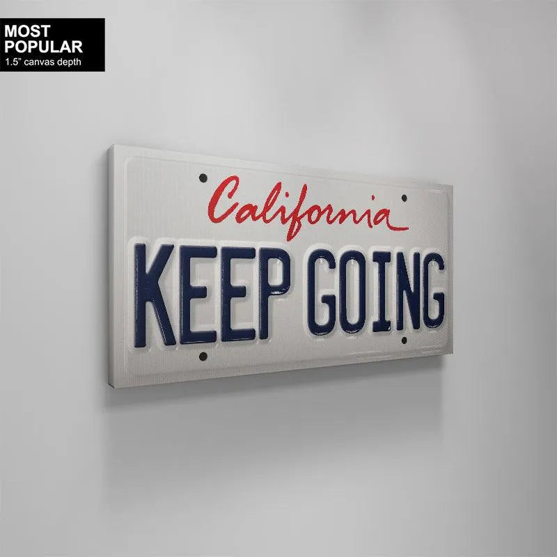 High-contrast image emphasizing the deep blue lettering against the bright white field of the 'Keep Going - CA' plate.