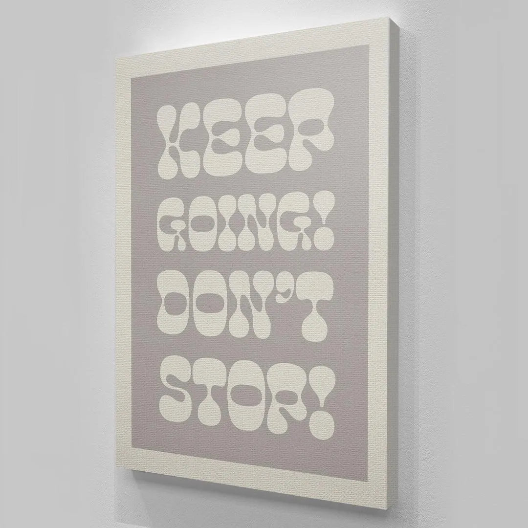 Vertical orientation display of the monochromatic grey and white "Keep Going! Don't Stop!" wall art in a modern interior.