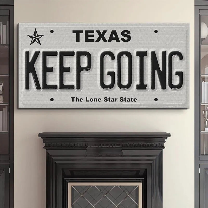 Lifestyle image showing the 'Keep Going - TX' sign mounted on a textured brick garage wall.