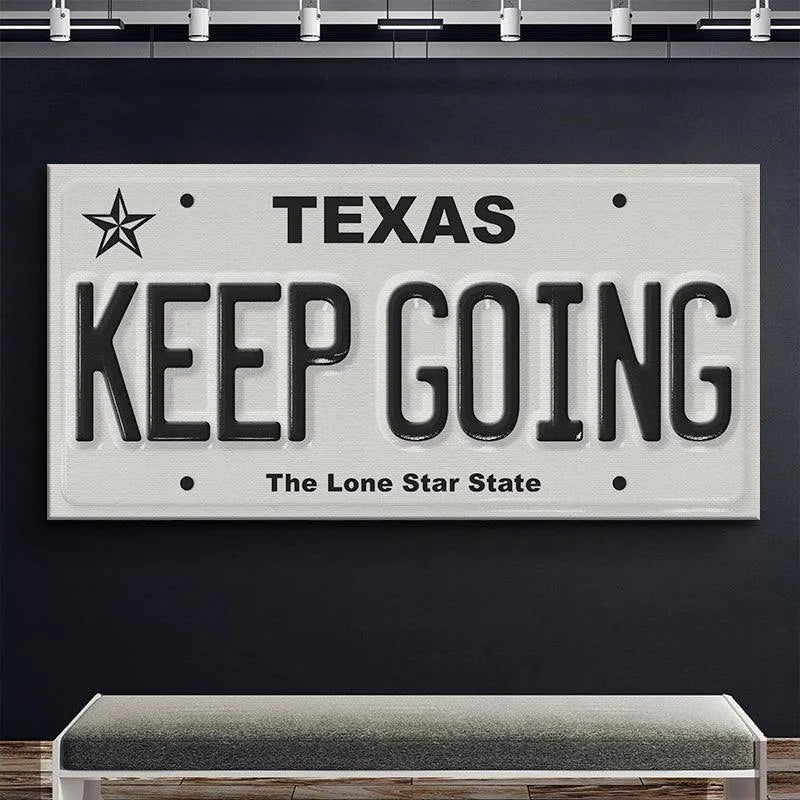 Macro photograph of the smooth texture and crisp edges of the 'Keep Going - TX' Texas motivational sign.