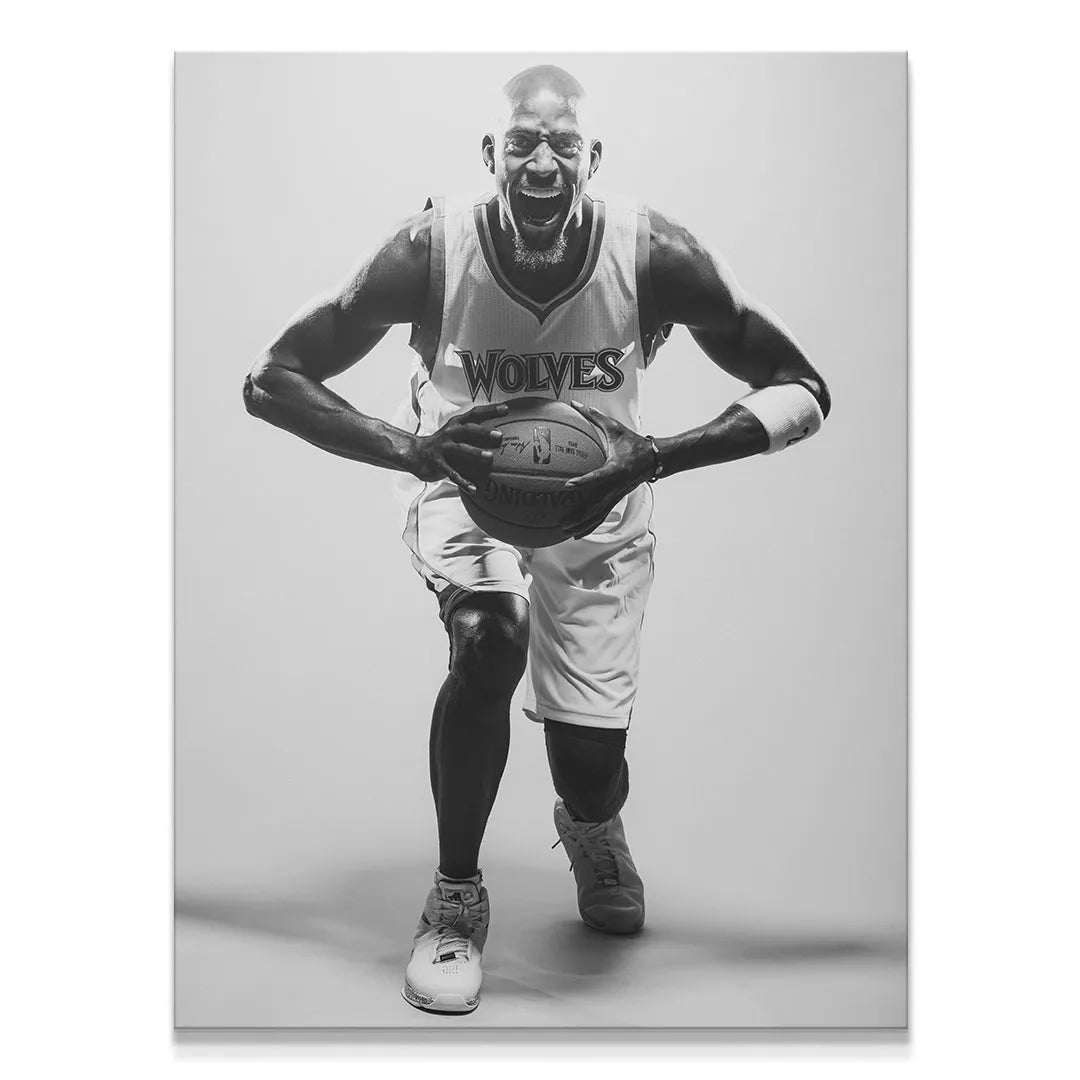 Full-body action shot in black and white of Kevin Garnett - #1 yelling and clutching a Spalding basketball.