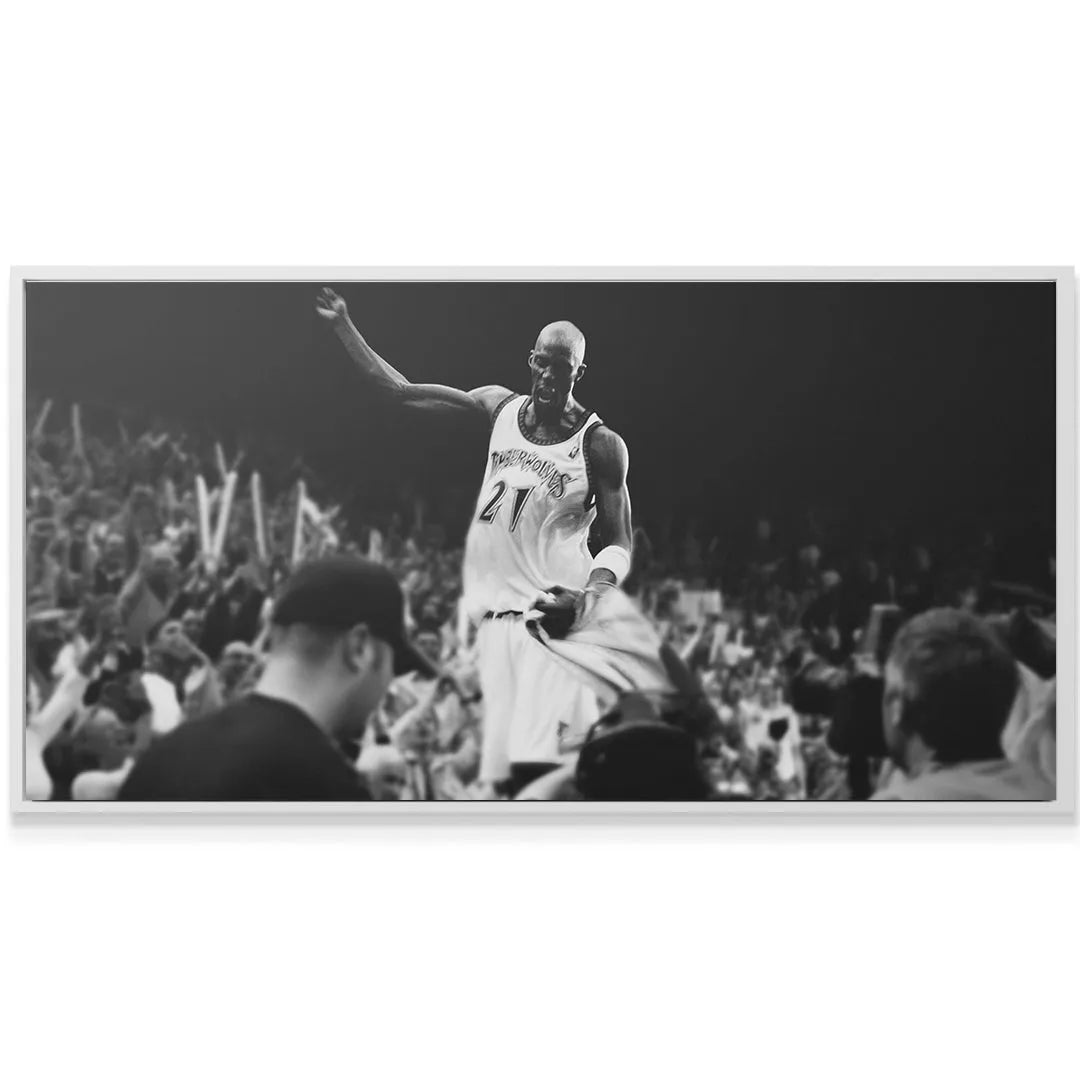 Dramatic low angle depiction of basketball superstar Kevin Garnett - #2 celebrating on court.