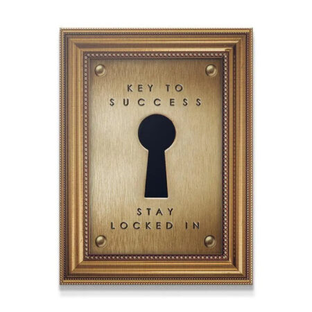 Close-up texture of the brushed gold plate displaying the bold letters of "Key To Success".
