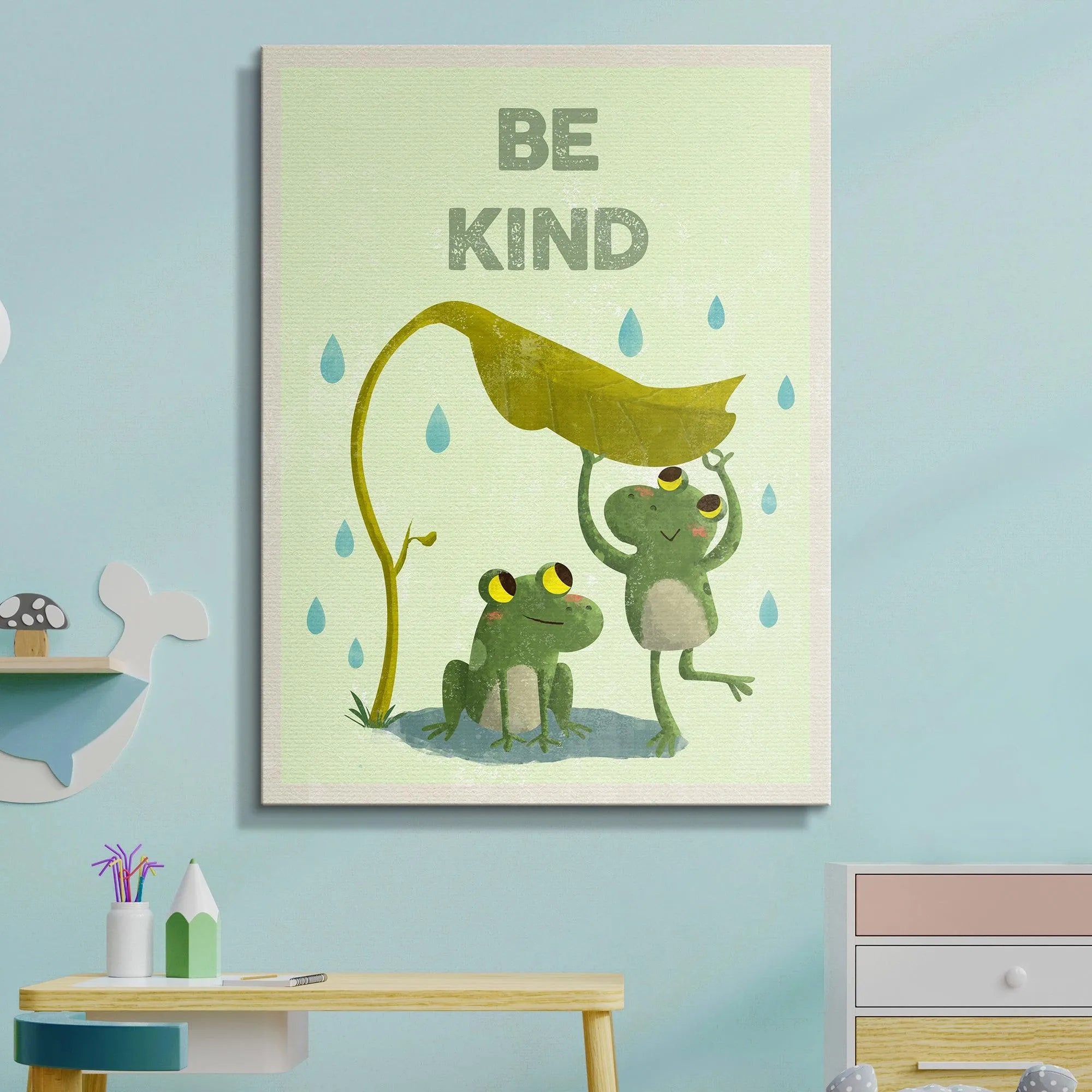Lifestyle mockup of the framed Kids Be Kind print displayed attractively in a child's bedroom setting.