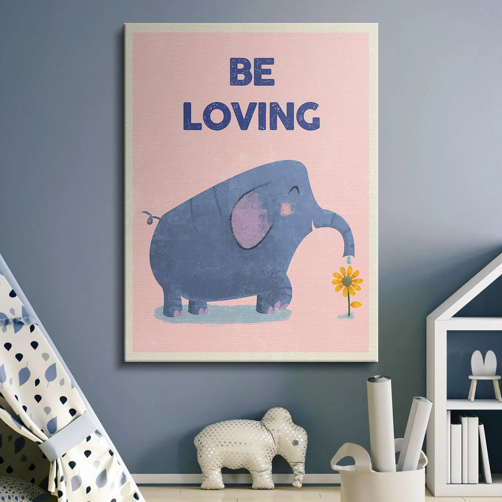 Horizontal shot showing the 'Kids Be Loving' poster framed and displayed above a white crib in a nursery setting.