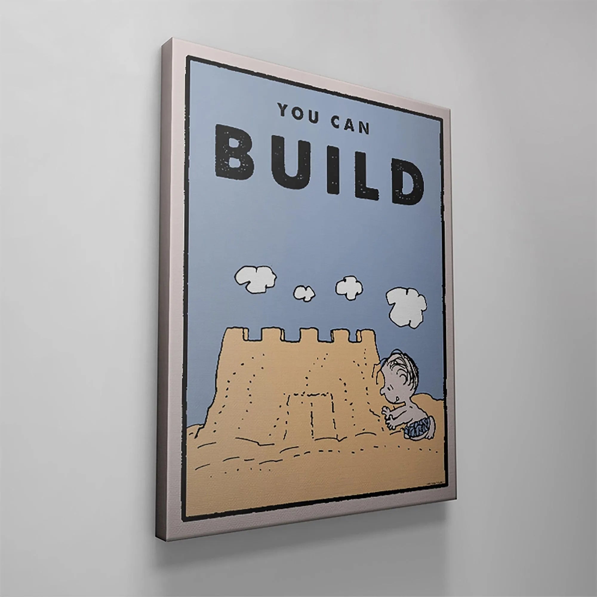Macro view focusing solely on the bold black "BUILD" text from the 'Kids PEANUTS - You Can Build' illustration.