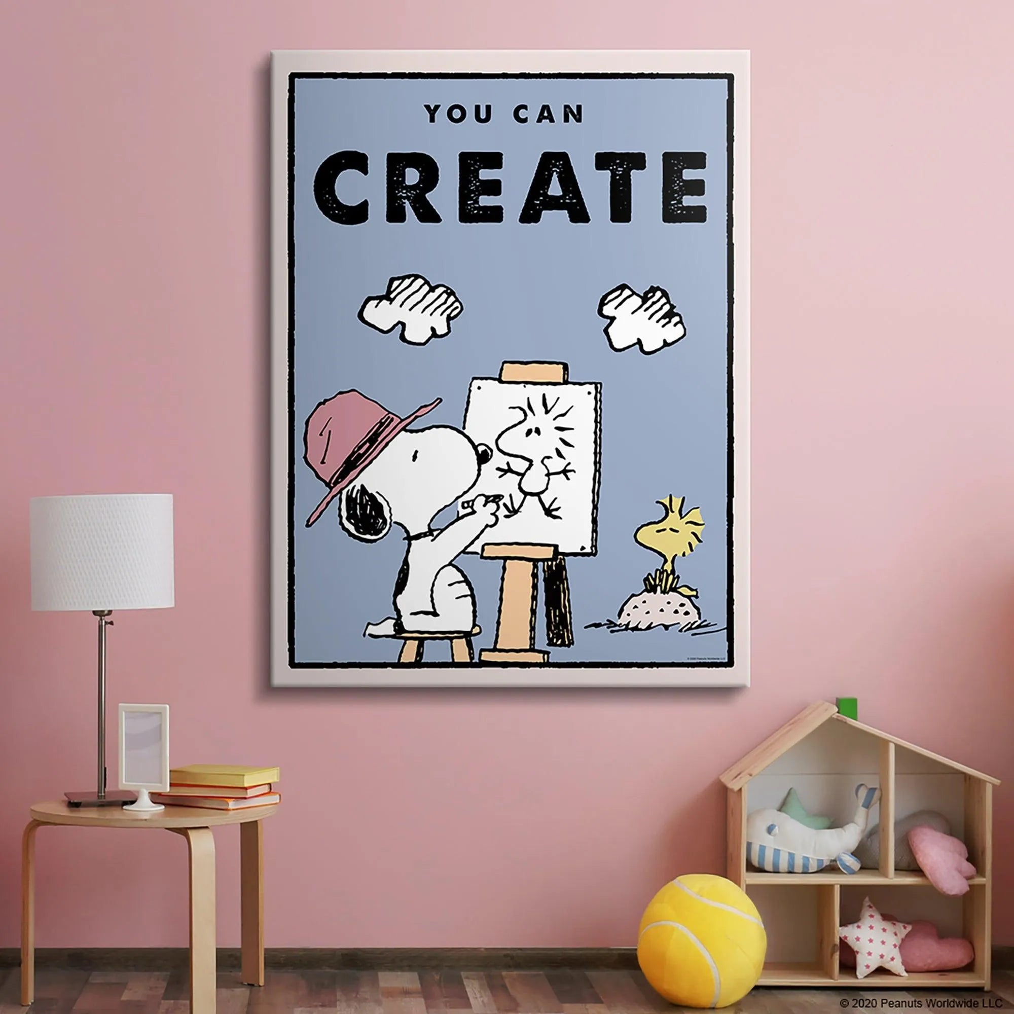 Detail shot focusing on Snoopy's paintbrush and the cheerful drawing on the easel in the 'Kids PEANUTS - You Can Create' scene.