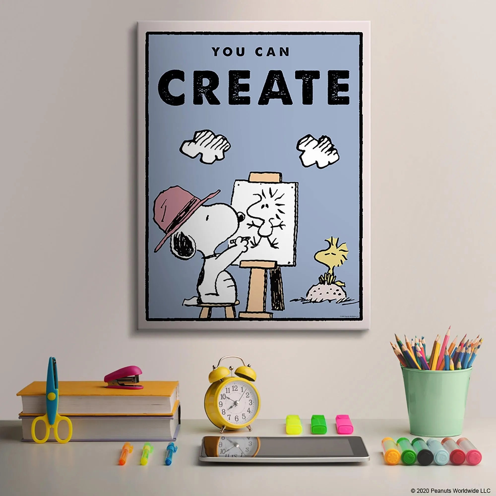Lifestyle photo of the 'Kids PEANUTS - You Can Create' poster placed above a child's crafting desk area.