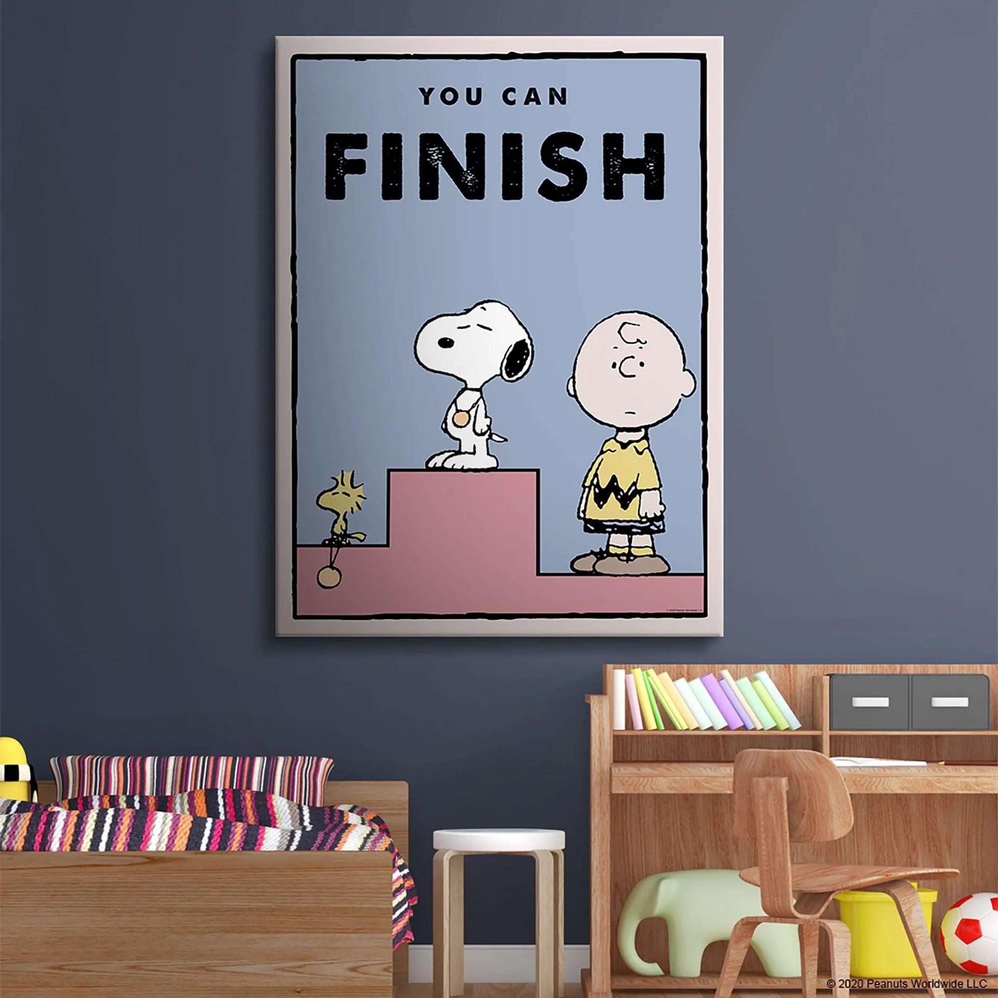 Wide shot of the print showing Charlie Brown and Snoopy on the tiered pink podium for Kids PEANUTS - You Can Finish.