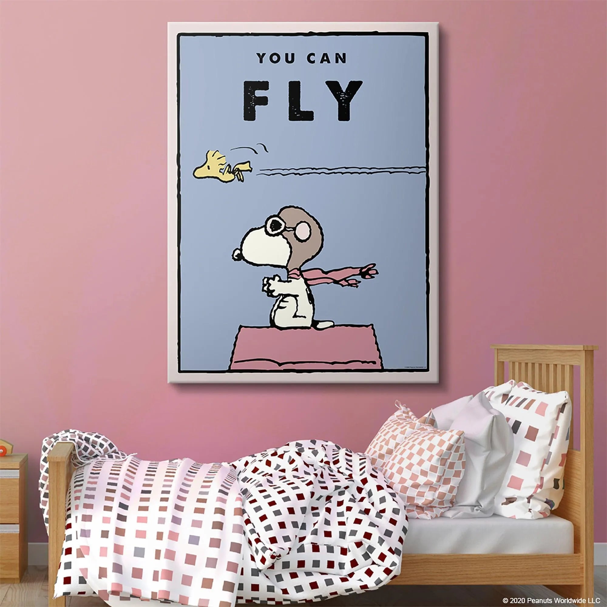 Lifestyle view: Kids PEANUTS - You Can Fly poster hanging centered in a brightly lit child's nursery.