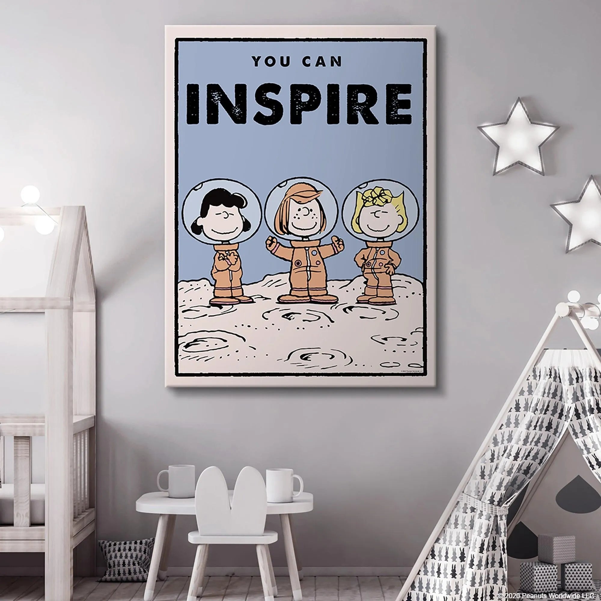 Detail crop showing Peppermint Patty smiling widely in her spacesuit on the lunar surface, part of the 'Kids PEANUTS - You Can Inspire' design.