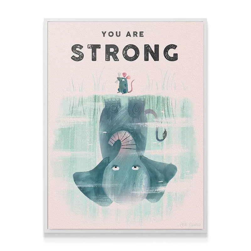 Lifestyle shot of the framed Kids You Are Strong print hanging above a minimalist crib in a modern children's nursery setting.