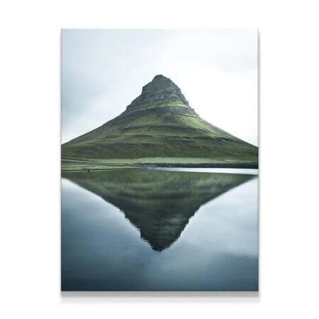 Full shot of Kirkjufell mountain reflected perfectly in still lake water.