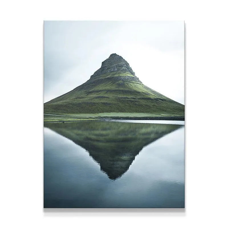 Full shot of Kirkjufell mountain reflected perfectly in still lake water.