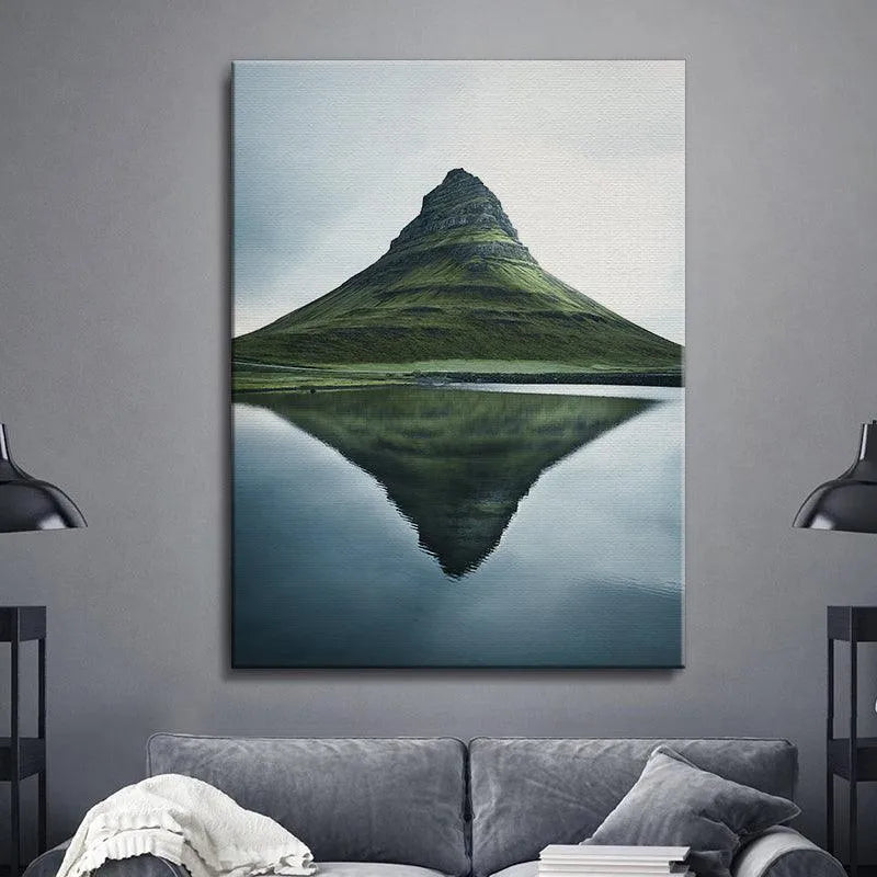 Wide angle landscape photograph featuring Kirkjufell under a muted, soft gray sky.