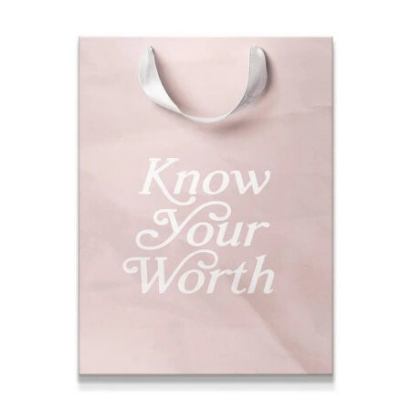 Full view of the blush pink gift bag featuring the 'Know Your Worth' script print.