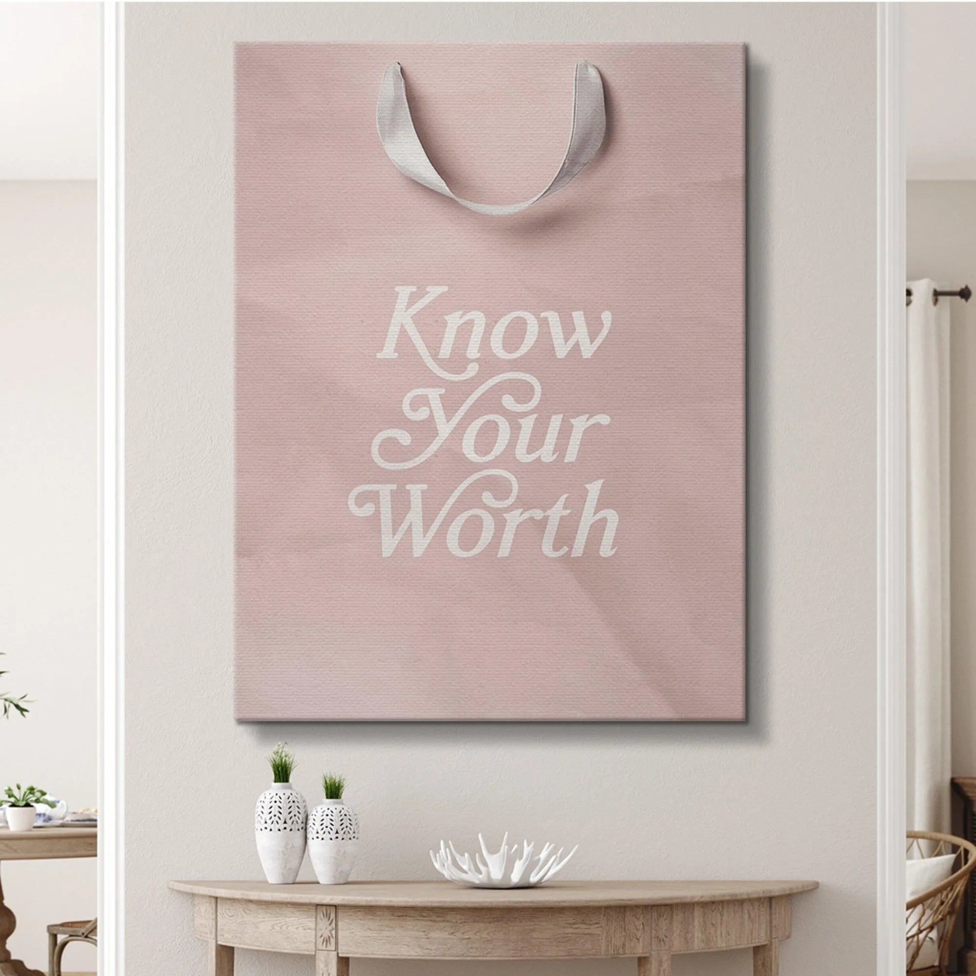 High-resolution crop focusing solely on the ornate white script lettering of 'Know Your Worth'.