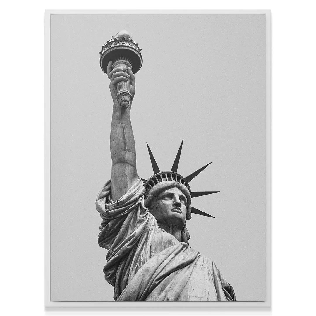 Lifestyle shot showing the large black and white Lady Liberty 2 canvas mounted in a modern living room setting.