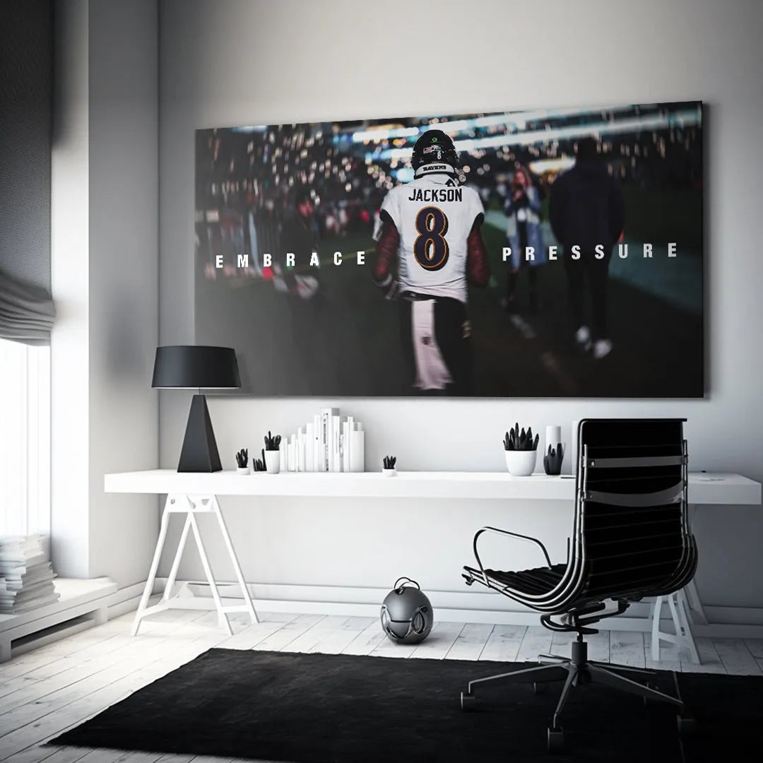 Lifestyle mock-up of the Lamar Jackson - Embrace Pressure motivational poster hanging on a dark wall.