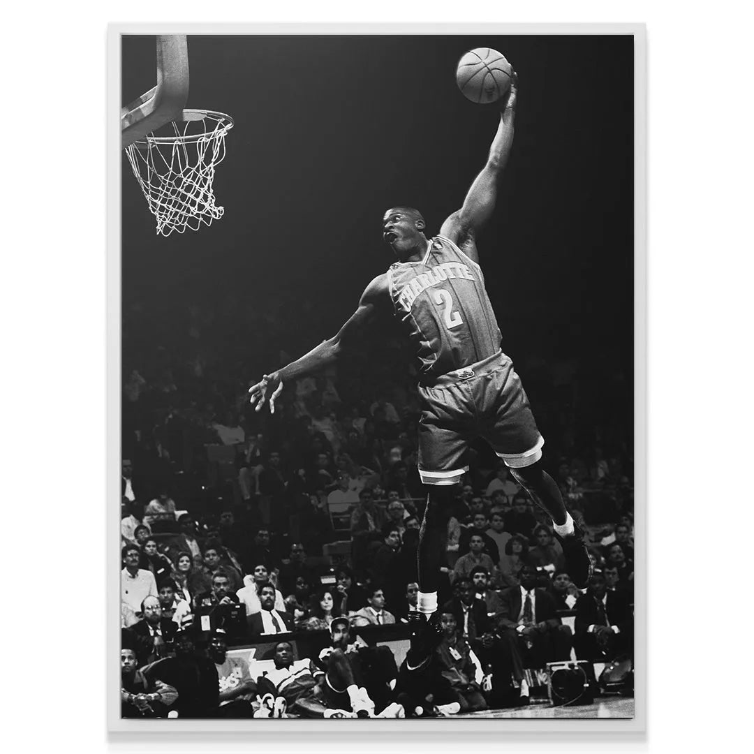 Wide-angle photograph showing the full arena atmosphere surrounding Larry Johnson - #1 during the pivotal play.