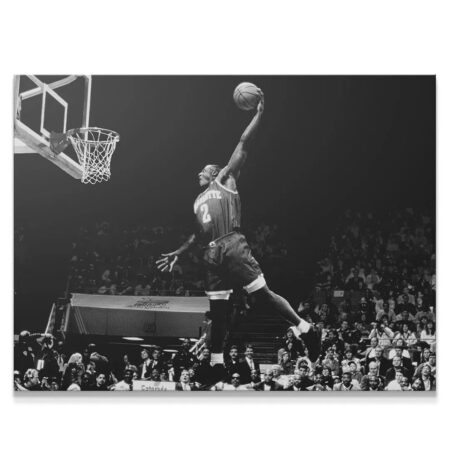 Dynamic aerial view of Larry Johnson - #2 completing a monstrous dunk in black and white.