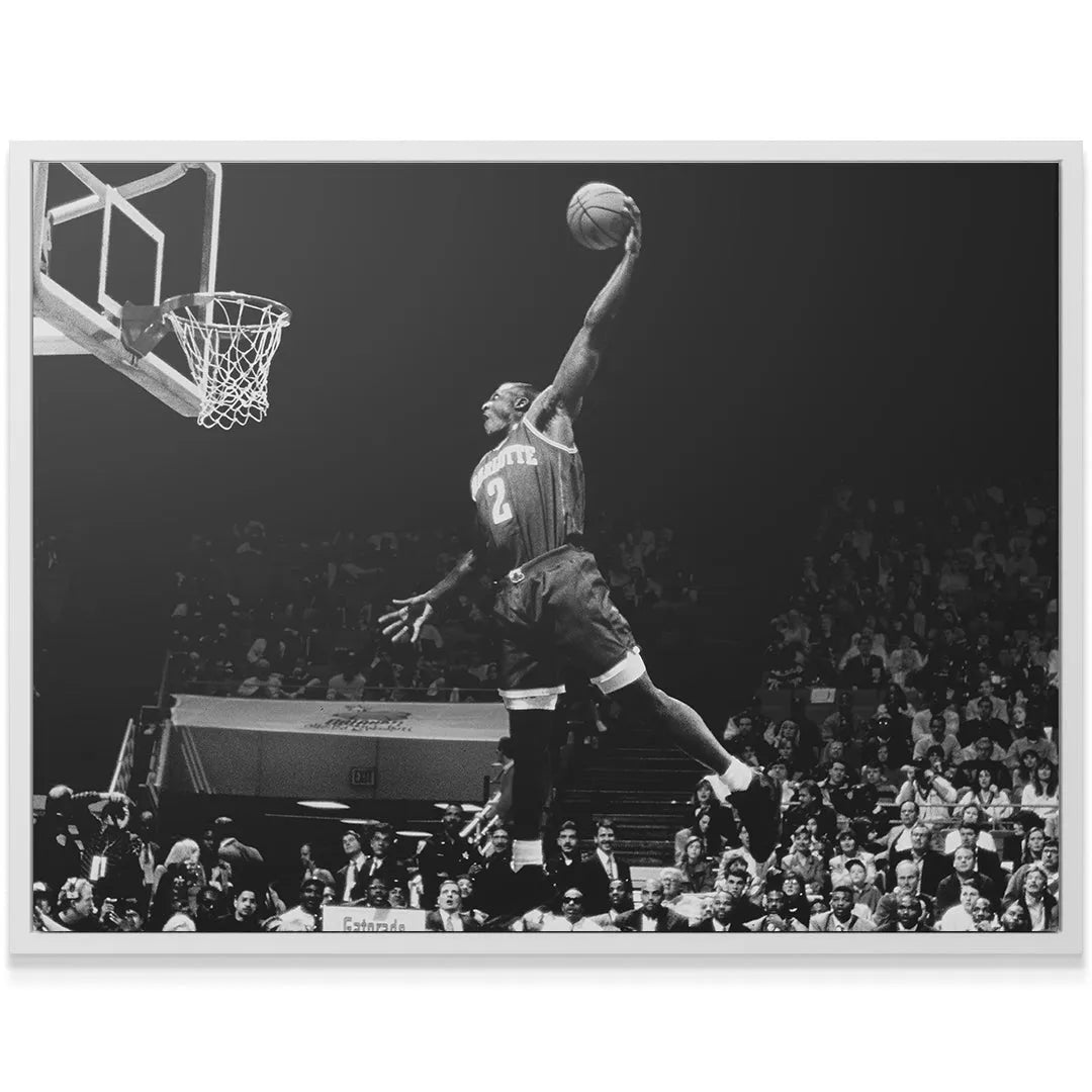 Detailed close-up showing the intensity on the face of Larry Johnson - #2 during his high-flying slam.