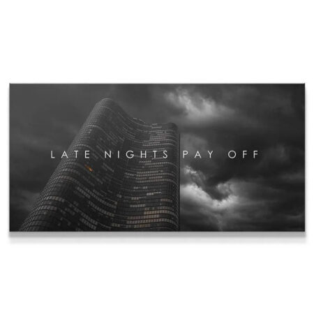 High-angle view of the dramatic skyscraper canvas artwork titled 'Late Nights Pay Off' against dark, stormy clouds.