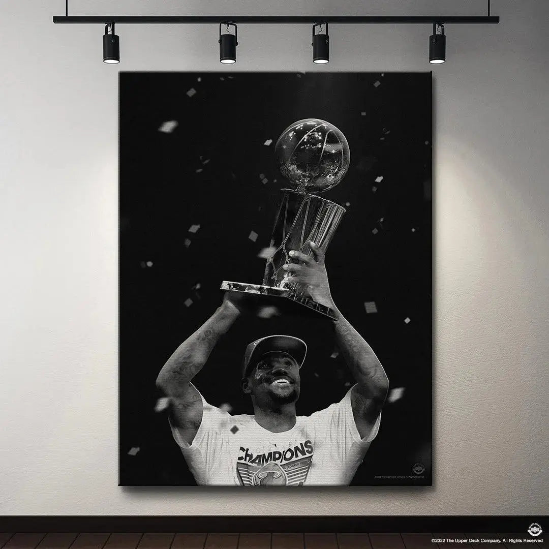 Focused shot on the 'CHAMPIONS' t-shirt and hat worn by LeBron James - The First during his victory celebration.