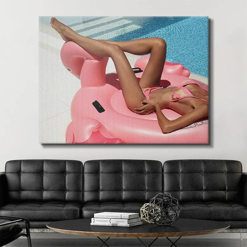 Detailed crop showing sun-kissed skin and pink bikini next to the inflatable, titled Leg Up.