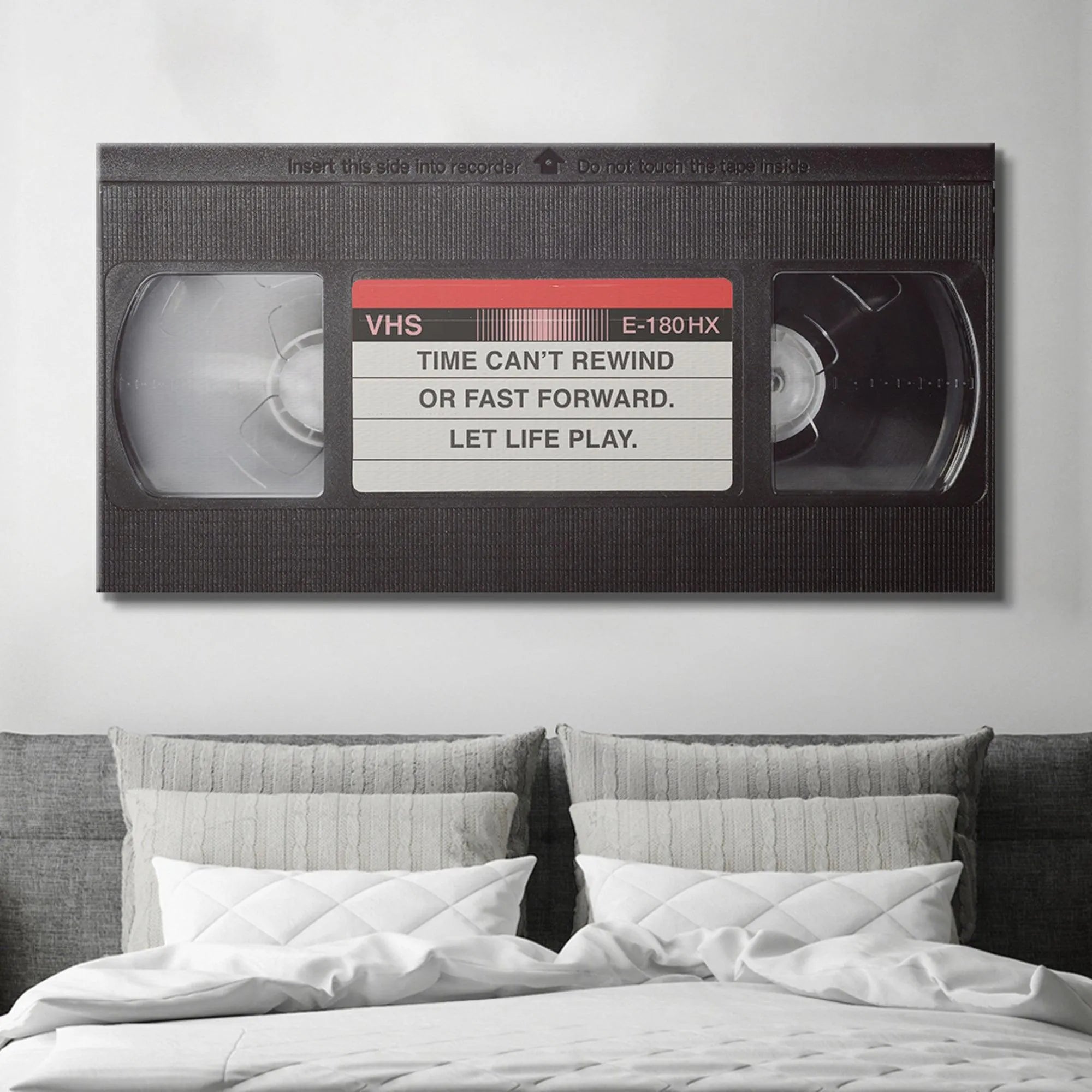 Detail of the internal tape spools visible through the cassette window, associated with the 'Let It Play' mandate.